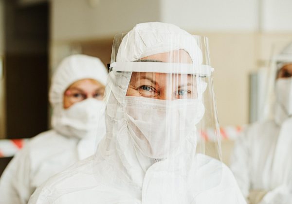 研可岸真题网用户支持人员正在回复反馈邮件，电脑旁贴着记录待办事项的便签，桌上有一杯已放凉的茶，整体画面平实而忙碌